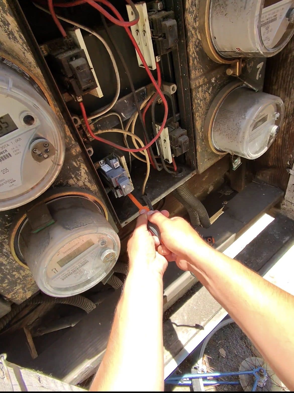 Electrician replacing an aging main disconnect in a multi-meter electrical service